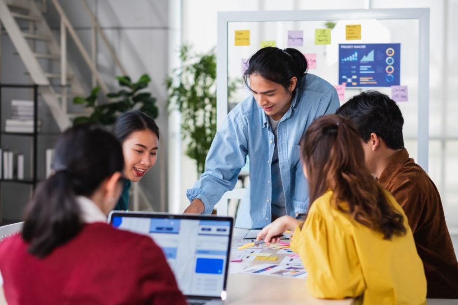 asian ux developer and ui designer brainstorming about mobile app interface wireframe design on meeting table with at modern office.Creative digital development agency